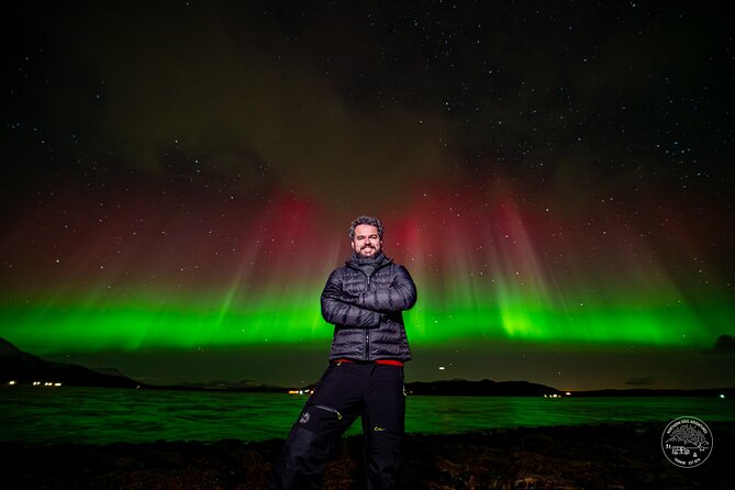 Small Group Van Journey in Search of the Northern Lights - Waiting outside with thermal gear and a fire